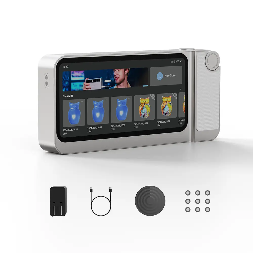 Toucan 3D Scanner, a compact handheld device with a touchscreen showing a scanning app. Includes power adapter, USB-C cable, turntable mat, adhesive markers. Available at 3DMakerPro.